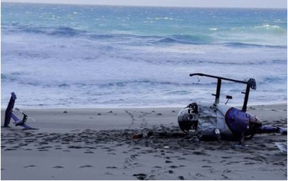 Photograph 1 – Image of fuselage and the separated empennage containing the vertical fin, horizontal stabilizer, and tail rotor, from the NTSB investigation of MD Helicopter 369E/500E accident near Kekaha, Hawaii, February 27, 2024