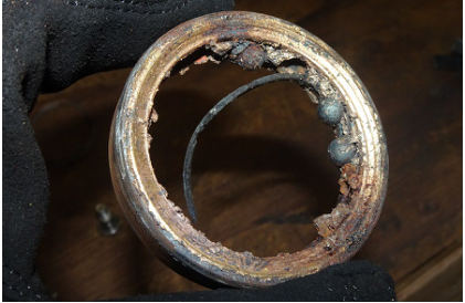 Photograph 3 – Image of clutch output bearing outer race with three roller elements adhered (NTSB Photo), from the NTSB investigation of MD Helicopter 369E/500E accident near Kekaha, Hawaii, February 27, 2024