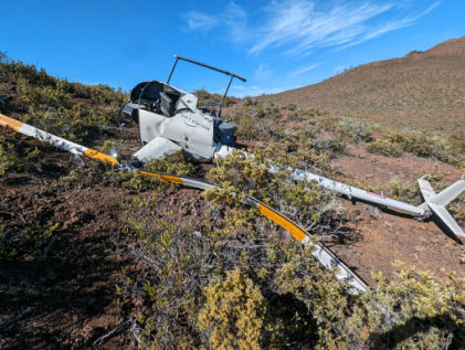 Photograph 3 – View of accident helicopter tail boom and rotor and fuselage, from the NTSB investigation of Robinson Helicopter R22 BETA accident near Kailua-Kona, Hawaii, May 30, 2024