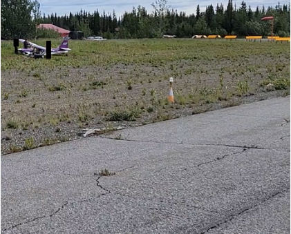 Photograph 1 – View of windsock and accident airplane., from the NTSB investigation of Foxair LLC KITFOX S7 SUPERSPORT accident near Tok, Alaska, July 9, 2024