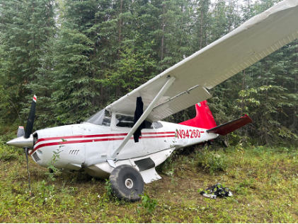 Photograph 2 – Left side view of accident airplane at accident site, from the NTSB investigation of Cessna A185F accident near Fairbanks, Alaska, August 8, 2024