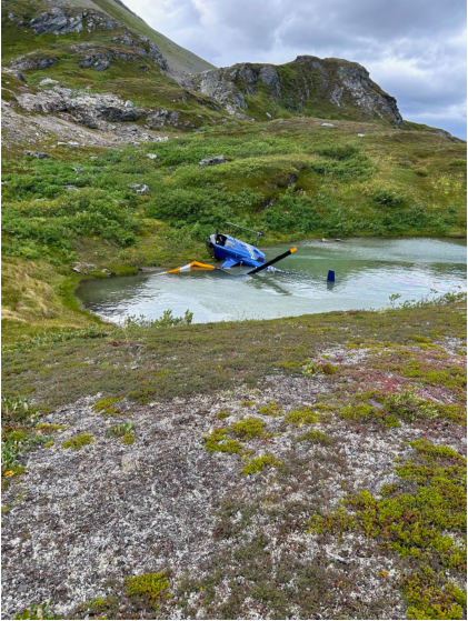 Photograph 1 – View of accident helicopter at accident site, from the NTSB investigation of Robinson Helicopter Company R44 II accident near Palmer, Alaska, August 18, 2024