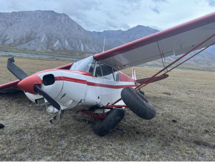 Photograph 1 – Image of fuselage, empennage, left wing, and landing gear, from the NTSB investigation of Piper PA-18-150 accident near Arctic Village, Alaska, August 16, 2024