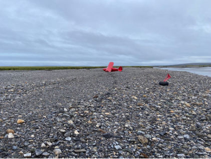 Photograph 2 – View of the airplane and the separated landing gear., from the NTSB investigation of Piper PA-22-150 accident near Sagwon, Alaska, August 25, 2024