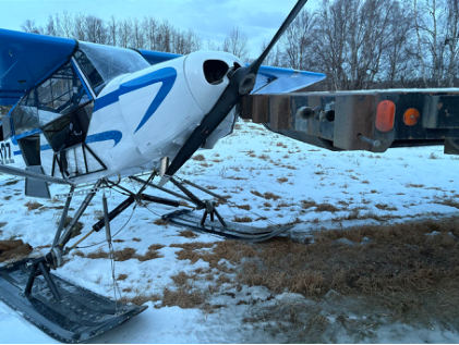 Photograph 1 – Accident airplane at accident site, from the NTSB investigation of Piper PA-18-150 accident near Palmer, Alaska, December 25, 2024