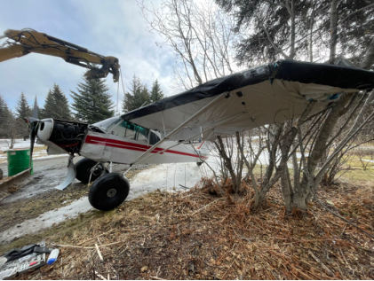Photograph 3 – Left side of accident airplane during recovery, from the NTSB investigation of Piper PA-18-150 accident near Anchor Point, Alaska, February 28, 2025