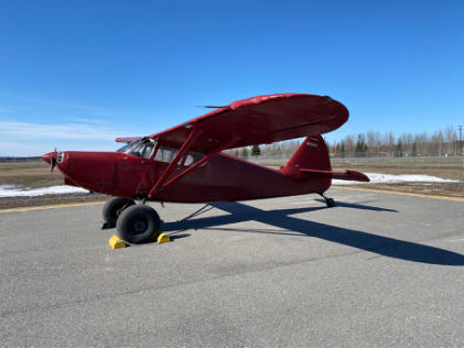 Photograph 1 – View of the airplane and damage to left wingtip, from the NTSB investigation of Stinson 108 accident near North Pole, Alaska, April 25, 2025
