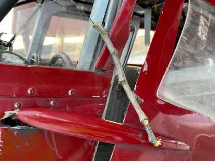 Photograph 3 – View of a stick lodged in the airframe around the windscreen, from the NTSB investigation of Stinson 108 accident near North Pole, Alaska, April 25, 2025