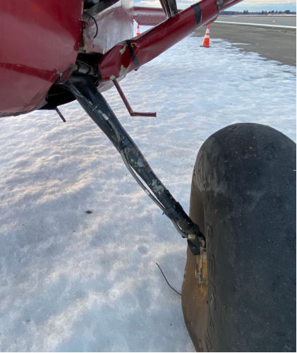 Photograph 4 – View of damage to left strut., from the NTSB investigation of Stinson 108 accident near North Pole, Alaska, April 25, 2025