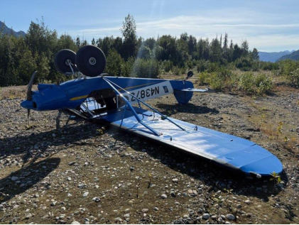 Photograph 1 – View of airplane where it came to rest inverted., from the NTSB investigation of Piper PA-18-150 accident near Willow, Alaska, August 18, 2025
