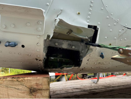 Photograph 3 – View of damage to the bottom of the fuselage, from the NTSB investigation of Cessna A185F accident near Haines, Alaska, August 18, 2025
