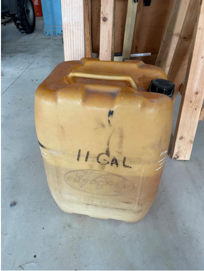 Photograph 11 – View of the pilot’s fuel container at his hangar at the airport, from the NTSB investigation of Vertical Aviation Technologies Hummingbird accident near Spring Branch, Texas, April 29, 2024