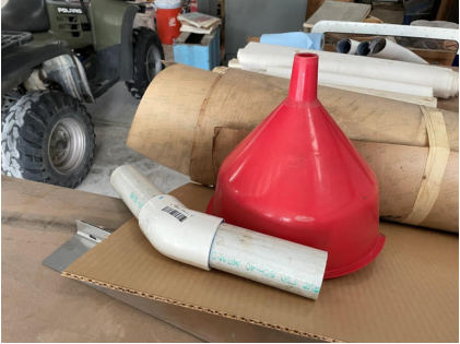 Photograph 12 – View of the pilot’s fuel funnel at his hangar at the airport, from the NTSB investigation of Vertical Aviation Technologies Hummingbird accident near Spring Branch, Texas, April 29, 2024