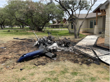 Photograph 5 – View of the wreckage in front of a house, from the NTSB investigation of Vertical Aviation Technologies Hummingbird accident near Spring Branch, Texas, April 29, 2024