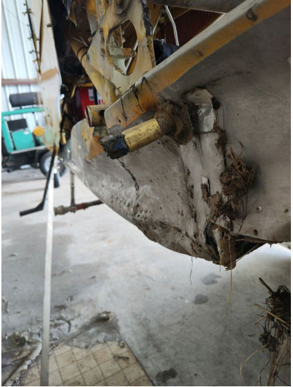 Photograph 5 – View of the substantial damage sustained to the right side of the lower fuselage, from the NTSB investigation of Ayres Corporation S2R accident near Stanwood, Michigan, June 20, 2024