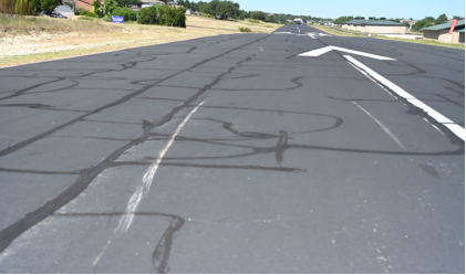 Photograph 1 – Impact marks on runway, from the NTSB investigation of Cirrus Design CORP SR22 accident near Lakeway, Texas, September 25, 2024