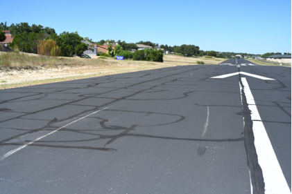 Photograph 2 – Impact marks on runway, from the NTSB investigation of Cirrus Design CORP SR22 accident near Lakeway, Texas, September 25, 2024