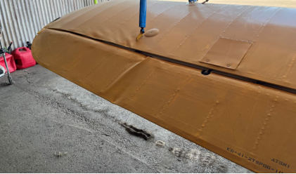 Photograph 3 – Left lower wing aileron damage, from the NTSB investigation of Boeing A75N1 accident near Denton, Texas, October 21, 2024