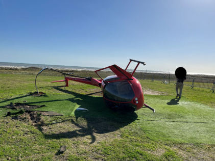 Photograph 1 – View of the front of the helicopter at the accident site, from the NTSB investigation of Robinson Helicopter R44 accident near Galveston, Texas, December 31, 2024