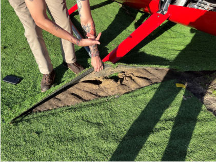 Photograph 6 – View of the helipad material, an artificial turf, from the NTSB investigation of Robinson Helicopter R44 accident near Galveston, Texas, December 31, 2024