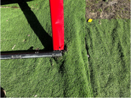 Photograph 7 – View of the right side skid and the artificial turf, from the NTSB investigation of Robinson Helicopter R44 accident near Galveston, Texas, December 31, 2024