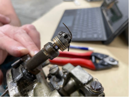 Photograph 7 – Mixture control arm and hardware, from the NTSB investigation of Piper PA-24-250 accident near Bentonville, Arkansas, January 16, 2025