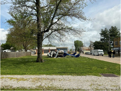 Photograph 9 – View of the accident site with the helicopter during the day, approximately facing to the north, from the NTSB investigation of Messerschmitt-Bolkow-Blohm BK 117 accident near Hartford, Illinois, April 25, 2025