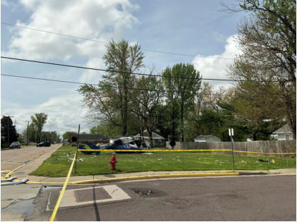 Photograph 11 – View of the accident site with the helicopter during the day, approximately facing to the south, from the NTSB investigation of Messerschmitt-Bolkow-Blohm BK 117 accident near Hartford, Illinois, April 25, 2025
