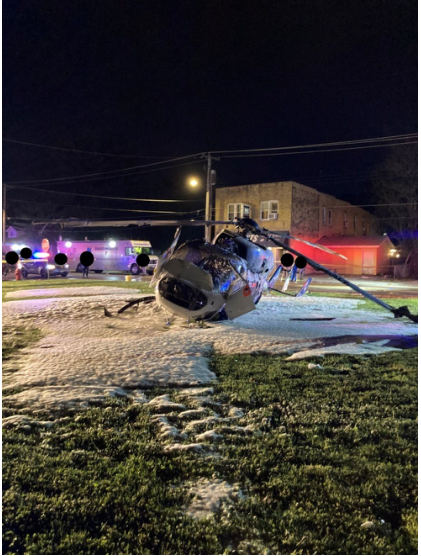 Photograph 4 – View of the front of the helicopter at the accident site at night, from the NTSB investigation of Messerschmitt-Bolkow-Blohm BK 117 accident near Hartford, Illinois, April 25, 2025
