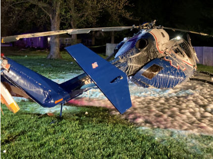 Photograph 7 – View of the right side of the helicopter at the accident site at night, from the NTSB investigation of Messerschmitt-Bolkow-Blohm BK 117 accident near Hartford, Illinois, April 25, 2025