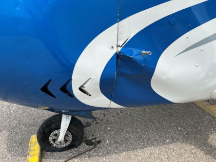 Photograph 3 – View of the left side fuselage, just aft of the engine compartment, from the NTSB investigation of Cessna 182 accident near Charlevoix, Michigan, June 2, 2025
