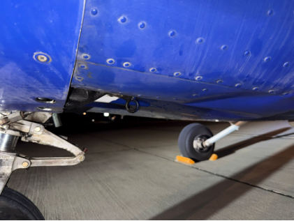 Photograph 2 – Side view of lower fuselage, from the NTSB investigation of Cessna 172R accident near Ardmore, Oklahoma, August 28, 2025