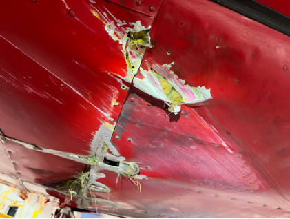 Photograph 2 – Lower fuselage of airplane, from the NTSB investigation of Piper PA-24-250 accident near Eau Claire, Wisconsin, October 19, 2025
