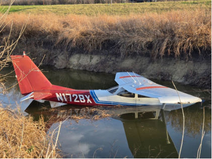 Photograph 1 – View of the right side of the airplane in the water, from the NTSB investigation of Cessna 172 accident near Taylor, Texas, December 26, 2025
