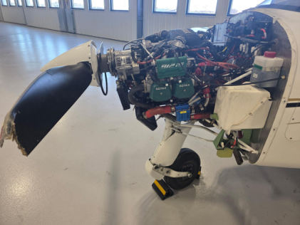Photograph 5 – Damage includes lower engine mount, propeller, and nose wheel steering rods, from the NTSB investigation of Costruzioni Aeronautiche Tecna P-MENTOR accident near Des Moines, Iowa, February 11, 2026