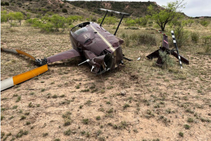 Photograph 3 – View of the main rotor system, the fuselage, and the tail rotor system at the accident site, from the NTSB investigation of Robinson Helicopter Company R44 accident near Mount Blanco, Texas, April 17, 2026