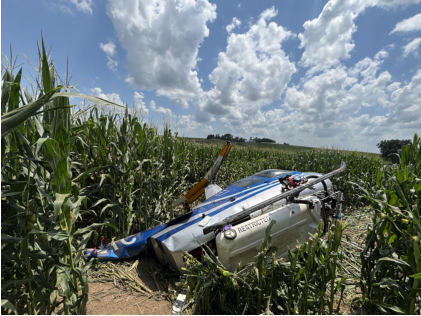 Photograph 2 – N322TC wreckage in corn field, from the NTSB investigation of Robinson Helicopter Company R44 II accident near Coralville, Iowa, July 16, 2026