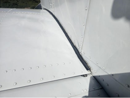 Photograph 2 – Left side fuselage damage at wing root, from the NTSB investigation of Piper PA-28-236 accident near Glenwood Springs, Colorado, May 3, 2026