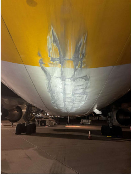 Photograph 1 – Lower fuselage damage near tail., from the NTSB investigation of Boeing 767 accident near San Bernardino, California, January 10, 2025