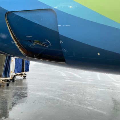 Photograph 1 – Damage to AFT Right Cargo Door and Frame, from the NTSB investigation of Boeing 737 accident near Kodiak, Alaska, January 15, 2026