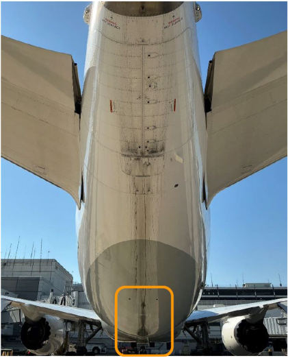 Photograph 1 – Damage to the lower fuselage. See photograph 2 for the area highlighted in the orange box., from the NTSB investigation of Boeing 787 accident near Houston, Texas, February 27, 2026