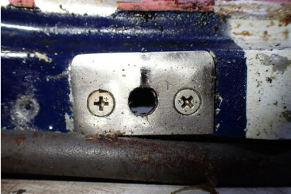 Photograph 7 – Main cabin door aft striker plate, from the NTSB investigation of Mooney M20K accident near St. Augustine, Florida, March 25, 2024