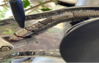 Photograph 4 – Close up view of loose B-Nut fitting hydraulic fluid leakage., from the NTSB investigation of Lockheed 12 accident near Jackson, Georgia, June 17, 2024