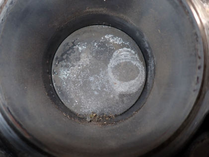 Photograph 10 – No. 1 piston with valve strike impressions, from the NTSB investigation of Williams John TITAN T-51 MUSTANG accident near Geneva, Ohio, July 21, 2024