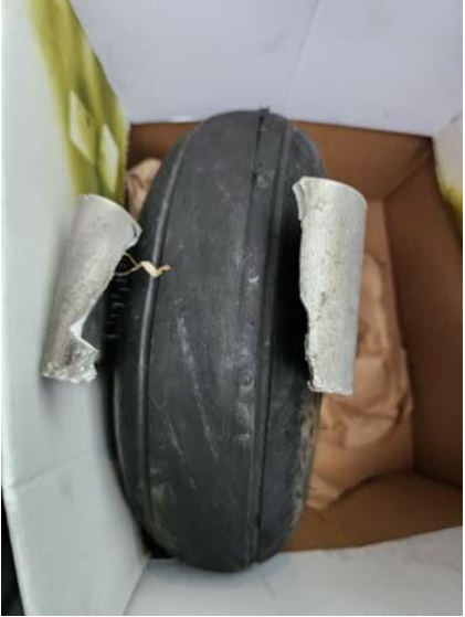 Photograph 6 – Nose wheel and attach bracket found at XSA, from the NTSB investigation of Golden Avio S R L F30 Brio accident near Midland, Virginia, December 31, 2023
