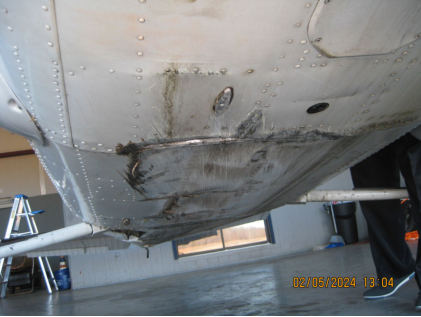 Photograph 2 – View of lower fuselage damage., from the NTSB investigation of Cessna R182 accident near Abingdon, Virginia, February 4, 2024