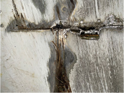 Photograph 3 – Close-up view of fuselage damage., from the NTSB investigation of Cessna R182 accident near Abingdon, Virginia, February 4, 2024