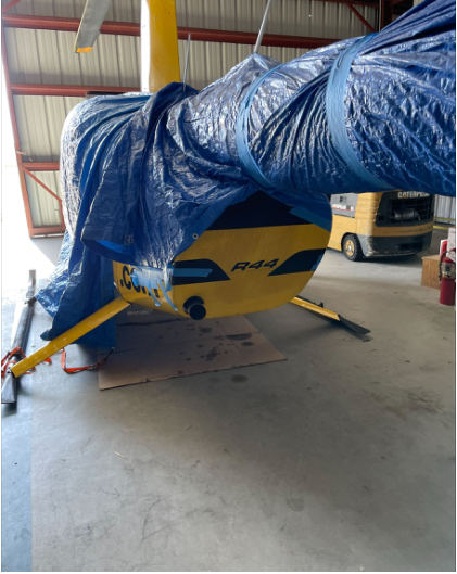 INVESTIGATIVE PHOTOS Photograph 2 – Helicopter with displaced skids, from the NTSB investigation of Robinson Helicopter Company R44 II accident near Miami, Florida, February 1, 2024