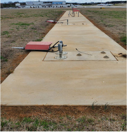 INVESTIGATIVE PHOTOS Photograph 3 –Damage to visual glide slope lights., from the NTSB investigation of Piper PA28 accident near Greensboro, North Carolina, March 8, 2024