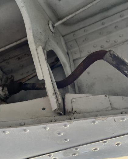 Photograph 4 – Bent right main landing gear push rod, from the NTSB investigation of Piper PA24 accident near Stafford, Virginia, March 7, 2024